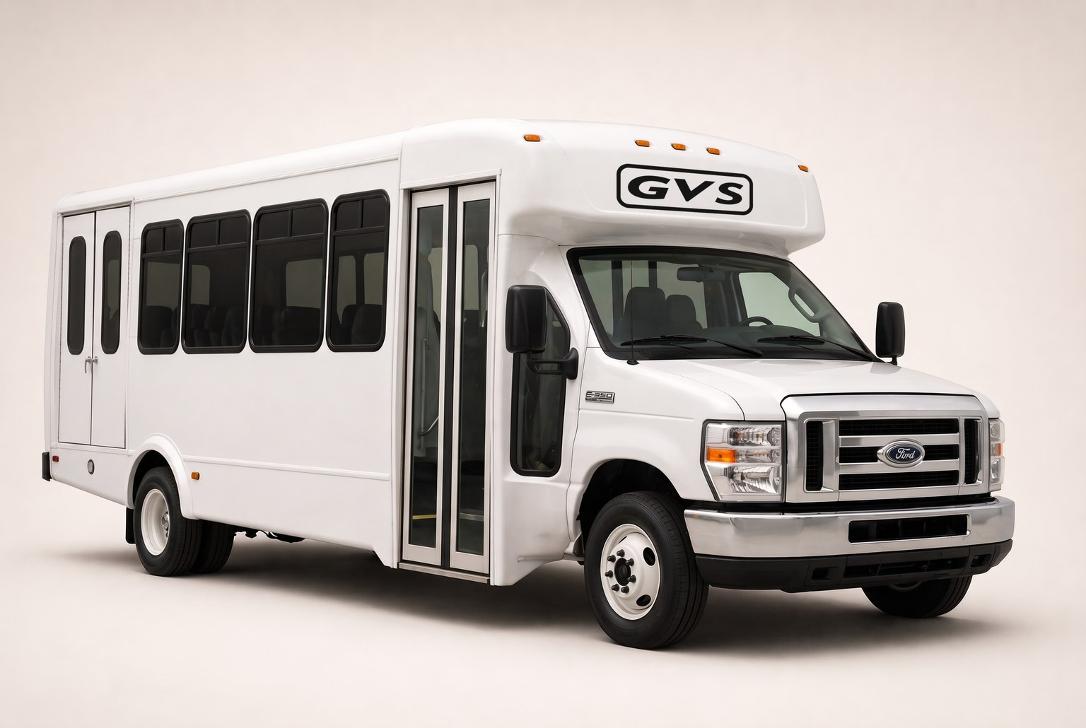Greene Valley Shuttle's wheelchair-accessible Ford E-350 — white 15-passenger shuttle bus with rear lift doors and the GVS mark above the windshield.